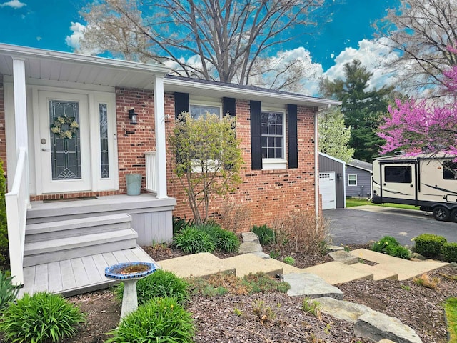 bungalow with brick siding and a detached garage