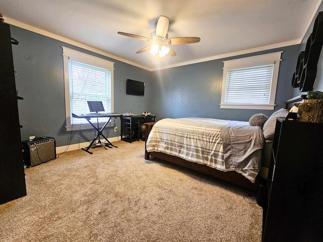 carpeted bedroom featuring crown molding, baseboards, and a ceiling fan