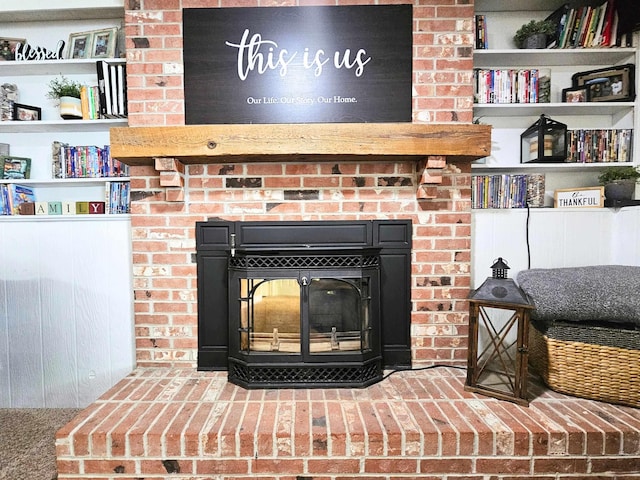 interior details featuring a brick fireplace