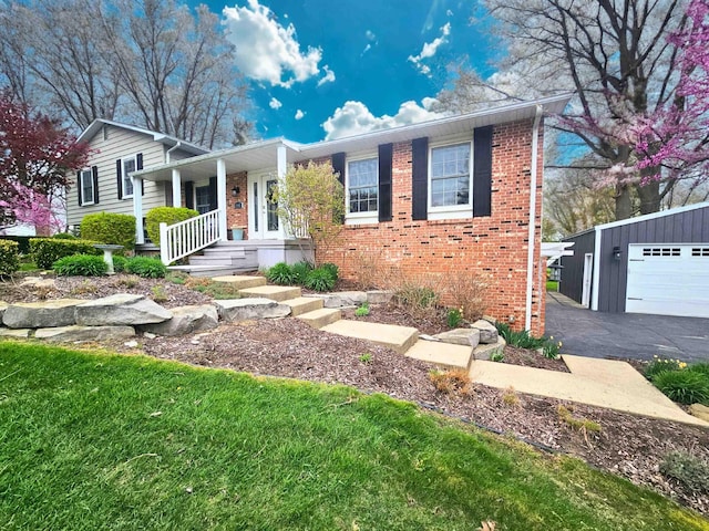 view of front of house with a garage, an outdoor structure, a porch, and brick siding