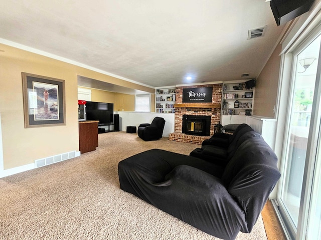 carpeted living room with a fireplace, baseboards, visible vents, and built in shelves