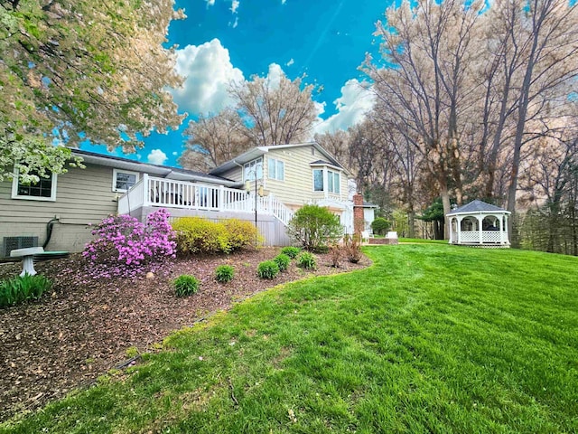view of yard featuring a gazebo and a deck