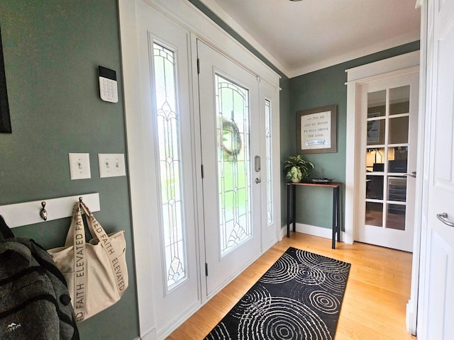foyer entrance featuring baseboards and wood finished floors
