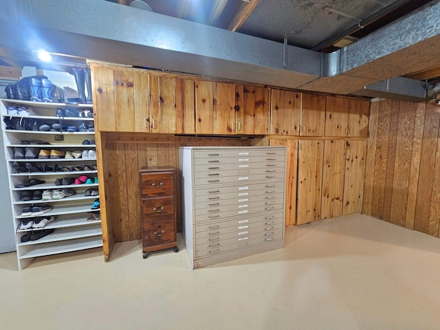 finished below grade area featuring wood walls