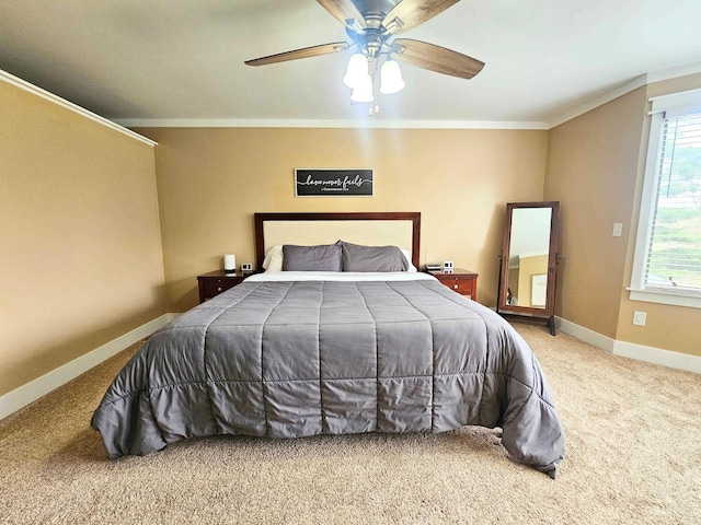 carpeted bedroom with crown molding, baseboards, and a ceiling fan