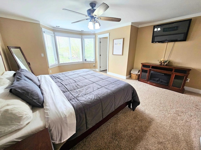 bedroom featuring baseboards, carpet flooring, a ceiling fan, and ornamental molding
