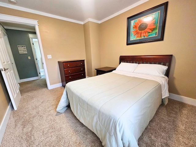 bedroom featuring crown molding, baseboards, and light colored carpet