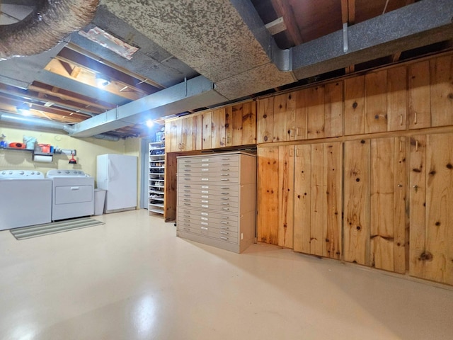 unfinished below grade area with freestanding refrigerator and washer and dryer