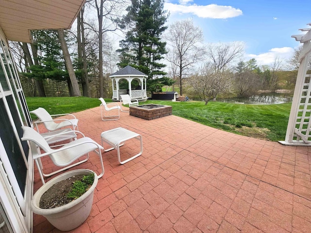 view of patio / terrace with a gazebo, a water view, a jacuzzi, and an outdoor fire pit