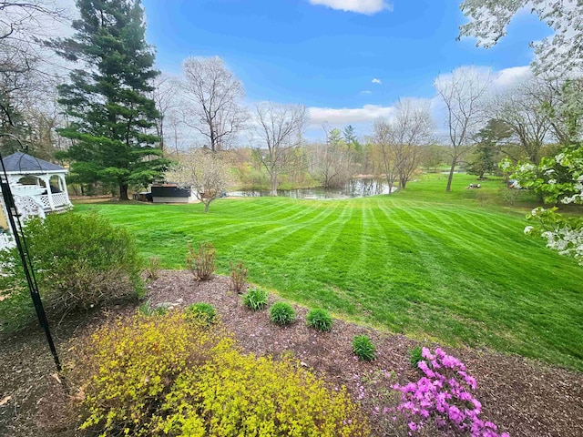 view of yard with a water view and a gazebo