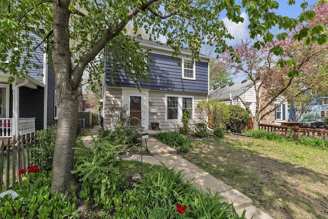 view of front facade featuring a fenced backyard and central air condition unit