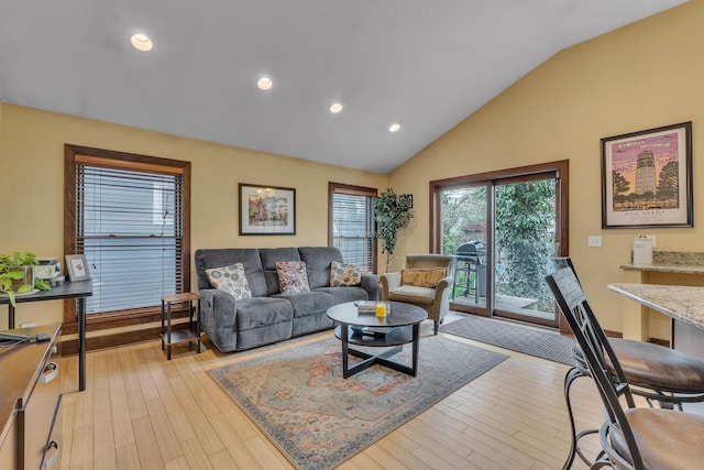 living room featuring high vaulted ceiling, recessed lighting, and light wood-style flooring