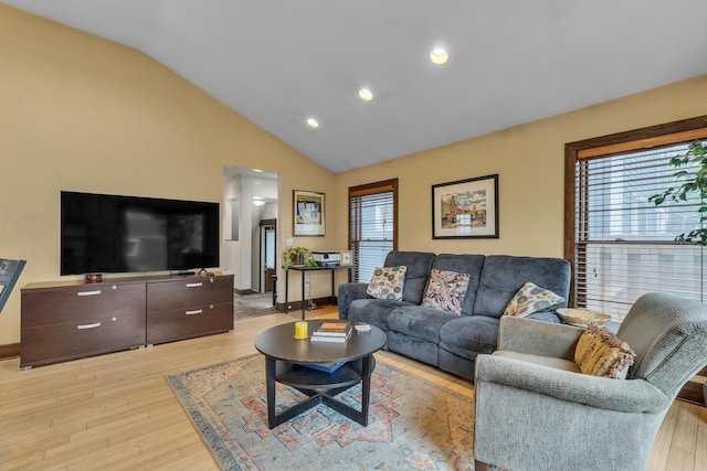 living room with light wood-style floors, recessed lighting, and high vaulted ceiling