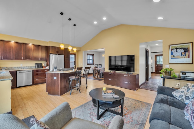 living area featuring light wood-type flooring, recessed lighting, and high vaulted ceiling