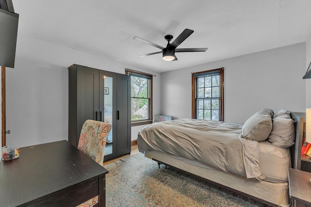 bedroom featuring light wood-style floors and a ceiling fan