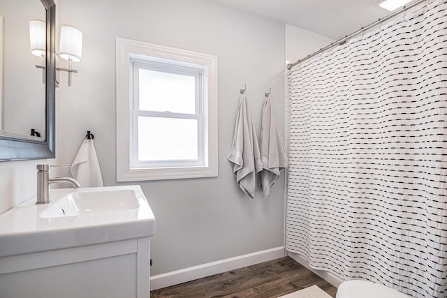 bathroom featuring vanity, baseboards, a shower with curtain, and wood finished floors