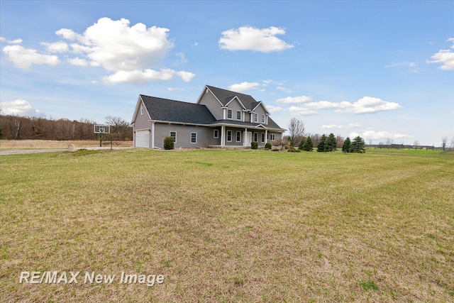 exterior space featuring an attached garage, a lawn, and covered porch