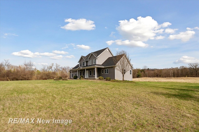view of property exterior featuring a yard and covered porch