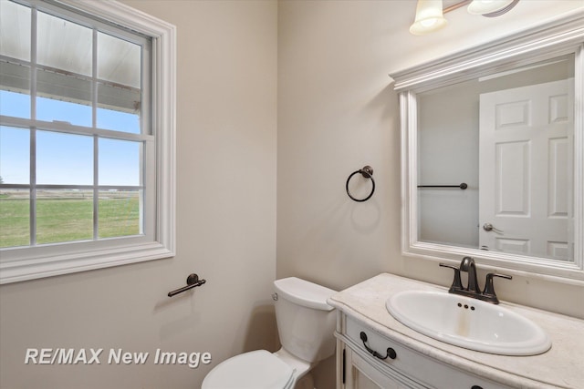 bathroom featuring vanity and toilet