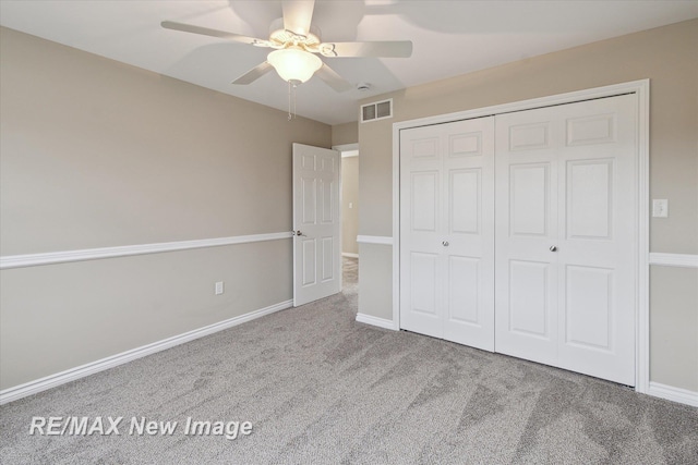 unfurnished bedroom with ceiling fan, visible vents, carpet floors, baseboards, and a closet