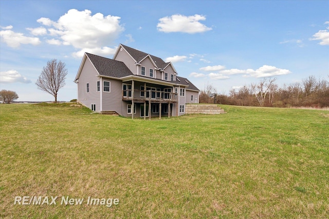 rear view of property with a lawn and a wooden deck