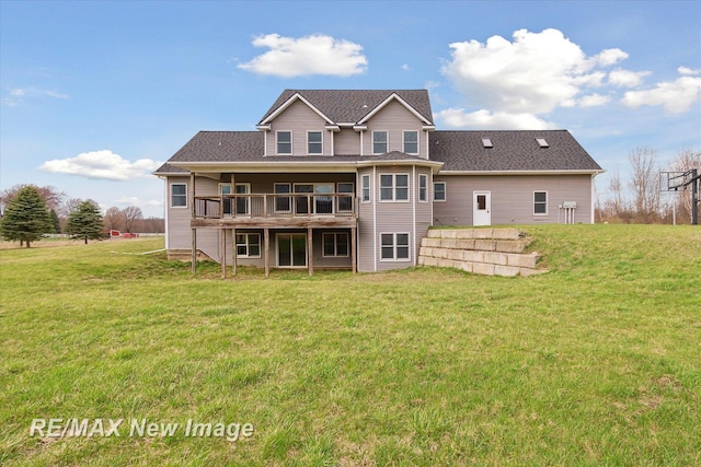 back of house with a lawn and a deck