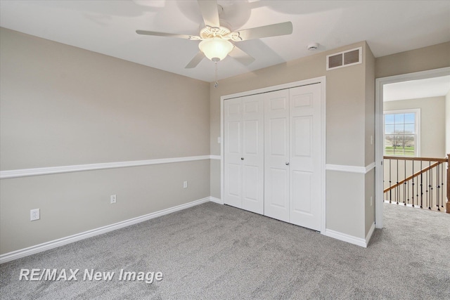 unfurnished bedroom with visible vents, carpet, baseboards, and a closet