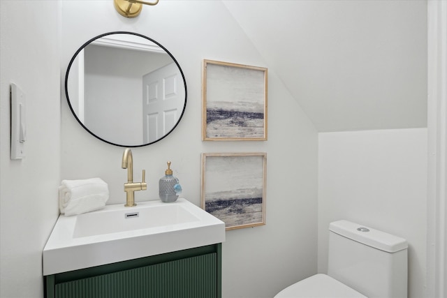 224 N Hewitt Rd, Ypsilanti, MI 48197 - half bathroom featuring toilet, vaulted ceiling, and vanity