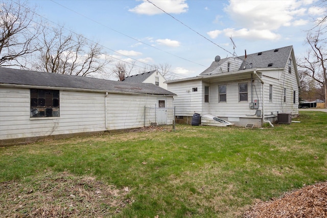 224 N Hewitt Rd, Ypsilanti, MI 48197 - back of property featuring a yard, central air condition unit, and roof with shingles