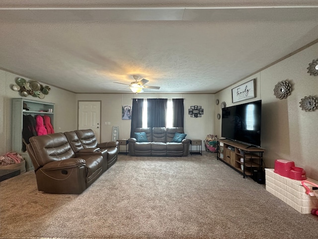 living room with carpet flooring, a textured ceiling, crown molding, and ceiling fan