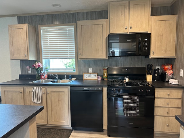 kitchen featuring a sink, light brown cabinetry, black appliances, and dark countertops
