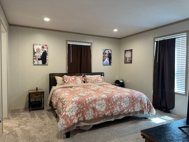 bedroom with recessed lighting, ornamental molding, carpet, and a decorative wall