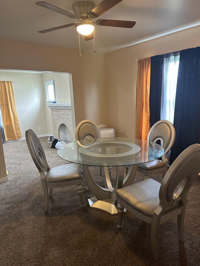 dining area with carpet floors, a ceiling fan, and baseboards