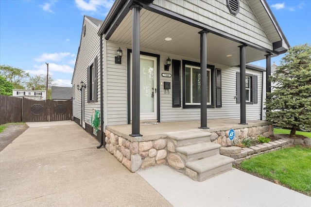 7960 Jackson St, Taylor, MI 48180 - shotgun-style home featuring covered porch, a gate, fence, and driveway