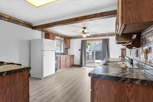 7960 Jackson St, Taylor, MI 48180 - kitchen with freestanding refrigerator, beamed ceiling, light wood-style flooring, and a sink