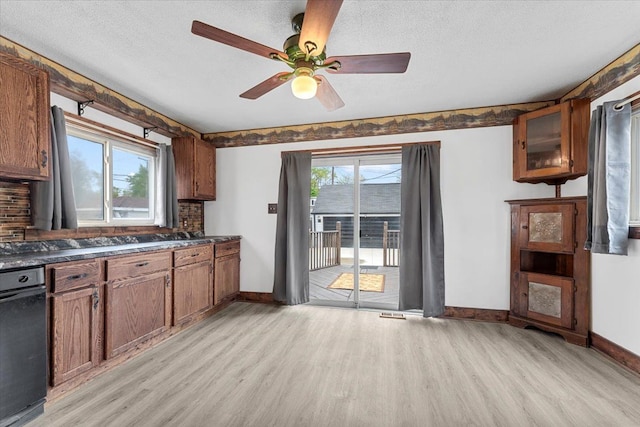 7960 Jackson St, Taylor, MI 48180 - kitchen with a textured ceiling, light wood finished floors, ceiling fan, baseboards, and dark countertops