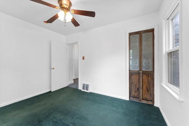 7960 Jackson St, Taylor, MI 48180 - spare room featuring baseboards, a ceiling fan, visible vents, and dark carpet