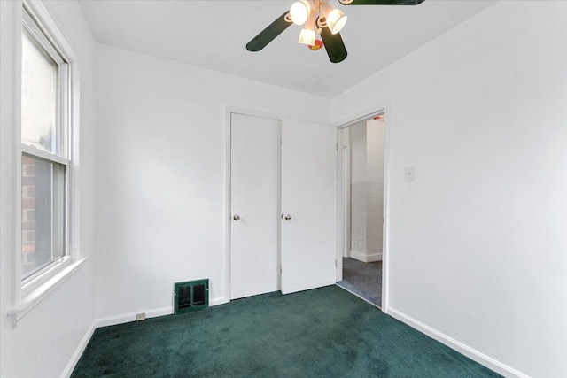 7960 Jackson St, Taylor, MI 48180 - unfurnished bedroom featuring ceiling fan, visible vents, baseboards, and dark carpet