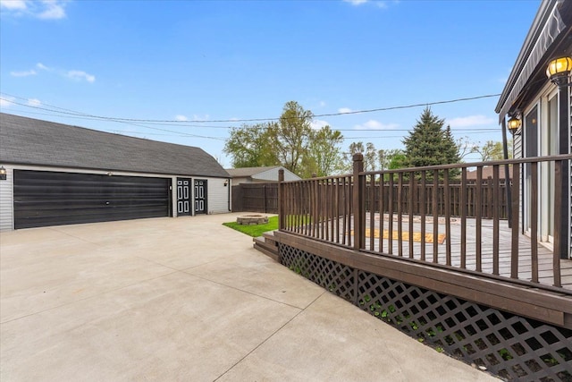 7960 Jackson St, Taylor, MI 48180 - view of patio with a garage, a fire pit, fence, a wooden deck, and an outdoor structure