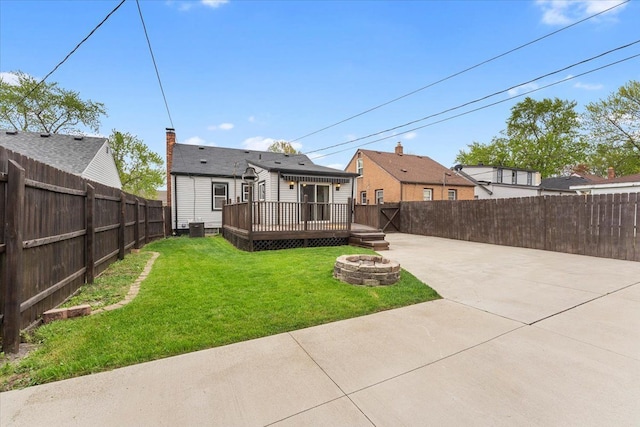 7960 Jackson St, Taylor, MI 48180 - view of yard with a fire pit, a patio, a deck, and a fenced backyard