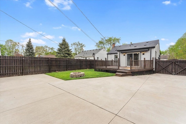 7960 Jackson St, Taylor, MI 48180 - rear view of property featuring a yard, a patio, an outdoor fire pit, a wooden deck, and a fenced backyard