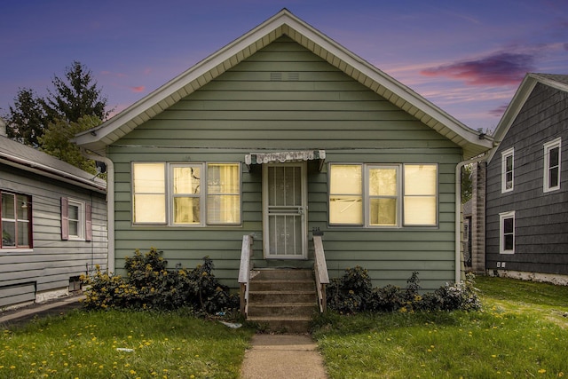 bungalow-style home featuring a lawn