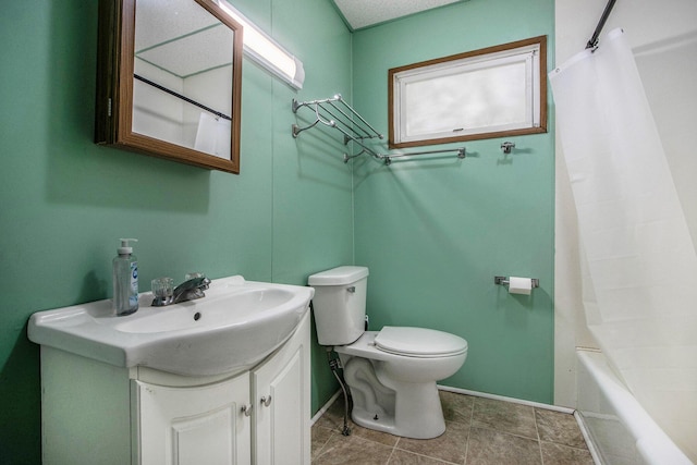 full bath featuring baseboards, vanity, and toilet