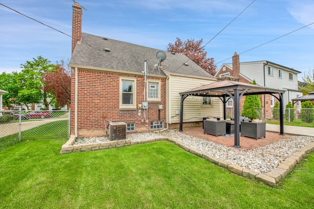 rear view of house featuring a fenced backyard, a gazebo, a yard, and outdoor lounge area