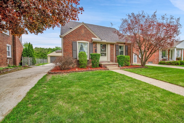bungalow-style home featuring brick siding, fence, roof with shingles, and a front lawn