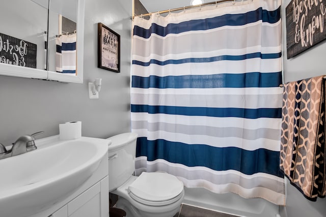 bathroom with vanity, a shower with shower curtain, and toilet