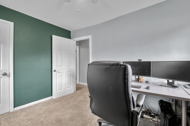 office space with carpet floors, a ceiling fan, and baseboards