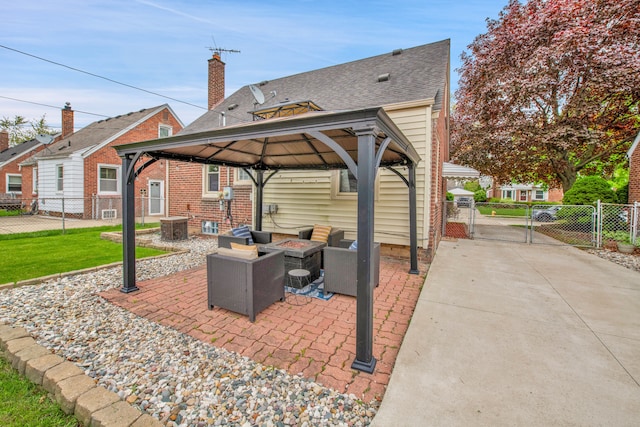 view of patio featuring a gate, a gazebo, fence, cooling unit, and an outdoor living space with a fire pit