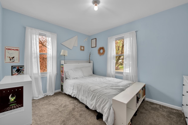bedroom featuring baseboards and carpet