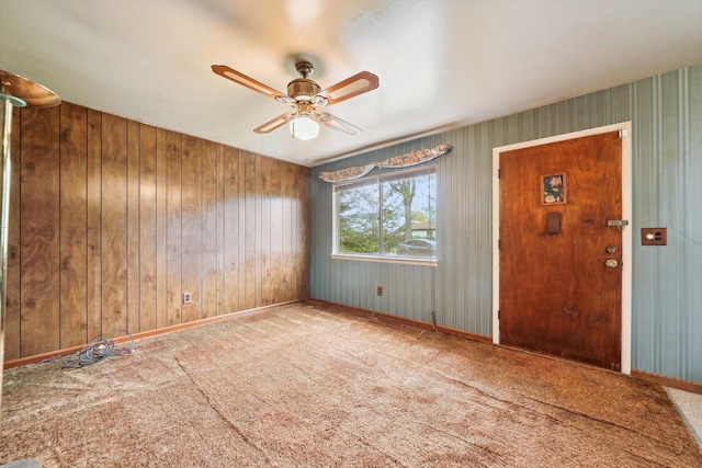 spare room with baseboards, carpet flooring, and ceiling fan